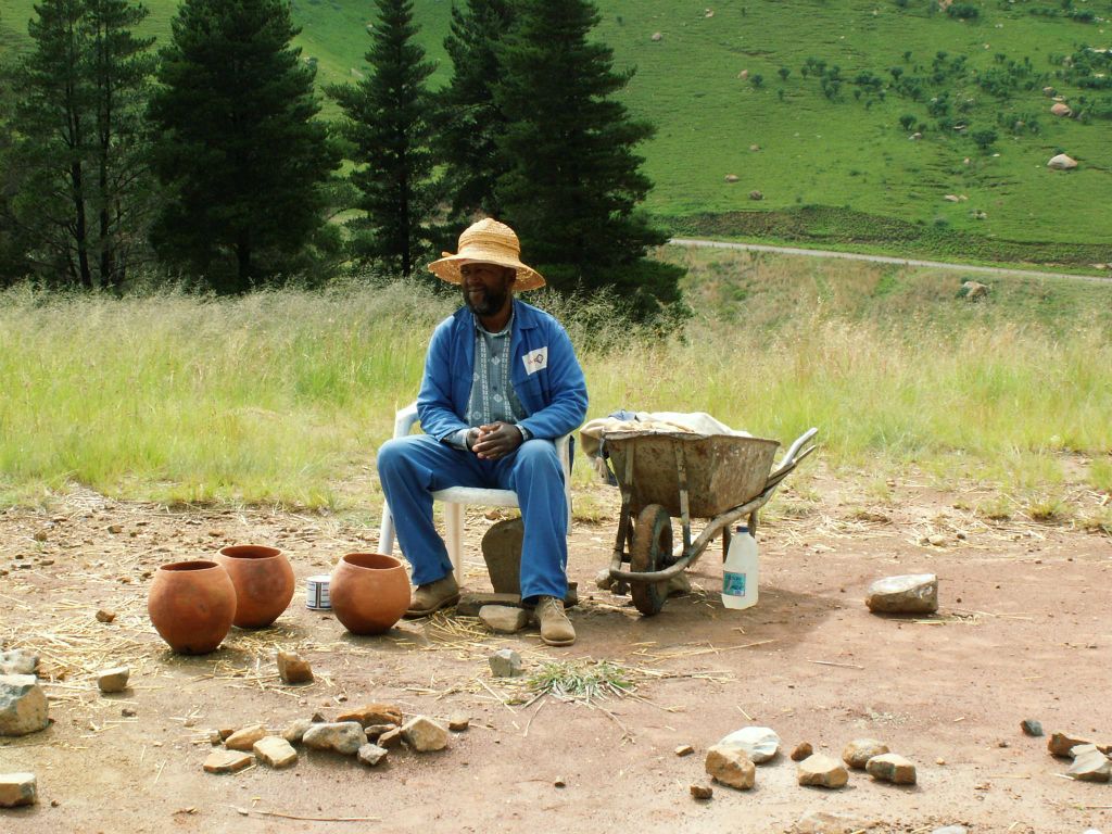 ROYAL NP -> LESOTHO - een man die kleine stenen huisjes maakt