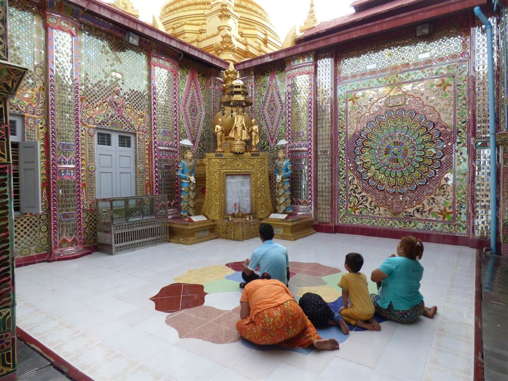 MANDALAY - enkele Myanmarezen bidden bij het Mandalay Hill complex