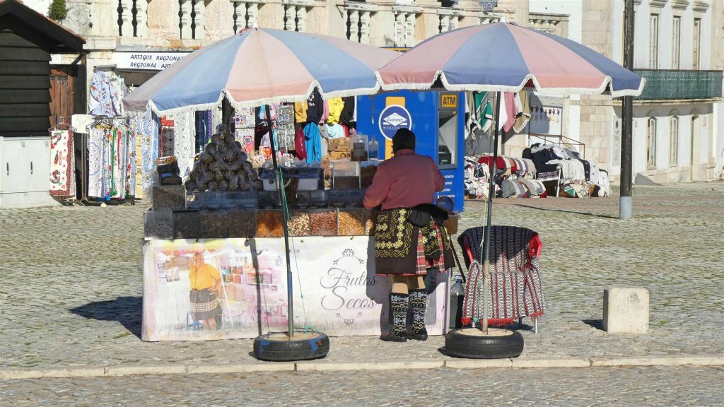 NAZARÉ - een vrouw bij een kraam in traditionele kleding